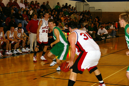 A Bounce Pass where the area of contact with the floor is closer then a third of the distance to the receiver will see the ball not bounce as high. This can make the receivers job all the more challenging. It is not uncommon to see a poorly executed Bounce Pass make contact with a post players leg before rolling away from a poor pass (Photo Source: eagle102.net)